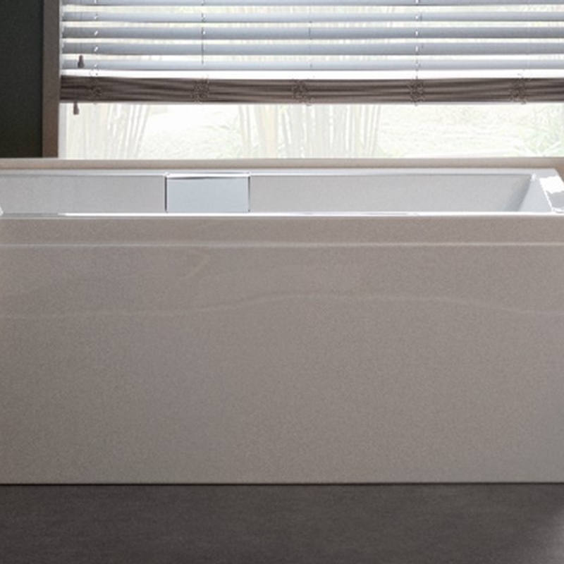 Carron built-in bath boxed into a panelled surround beneath a window in a UK bathroom - the fitted, space-saving alternative to a sculptural freestanding bath, accessed through a removable front panel