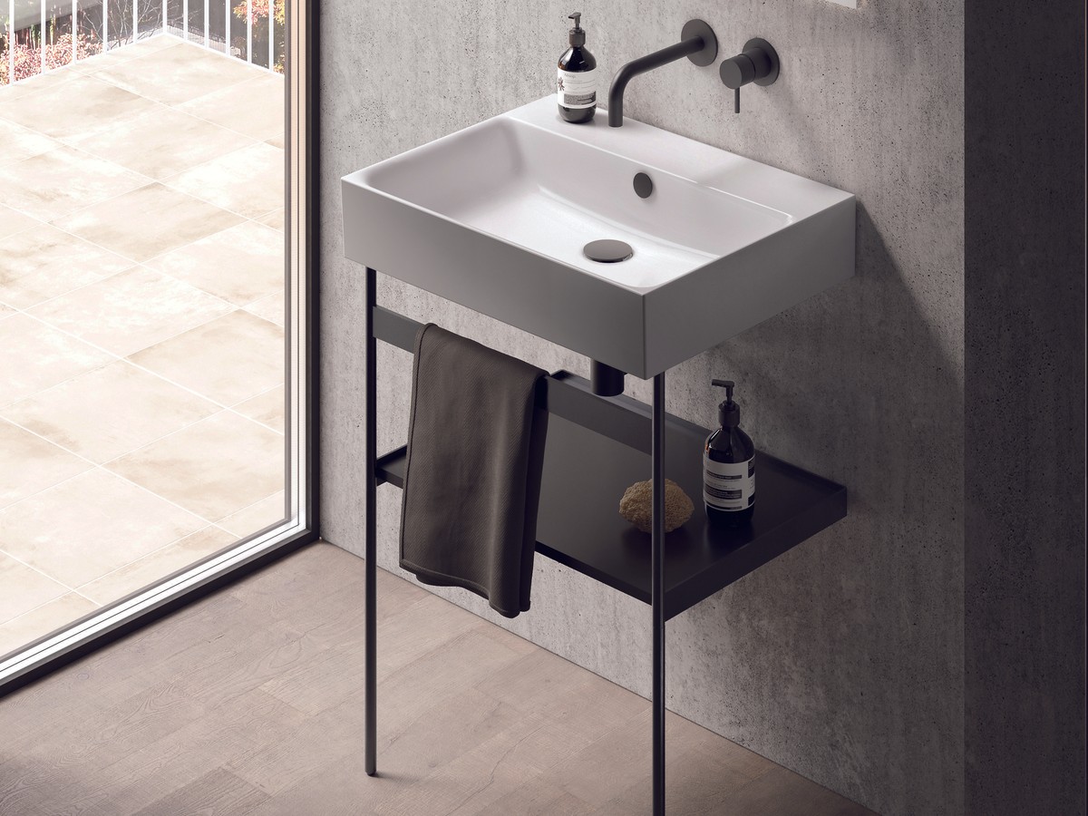 UK luxury bathroom with built-in bath ensemble - Catalano premium ceramic basin and WC, brushed brassware, large-format stone tile, coordinated lighting - the built-in scheme that reads as luxurious through coordination rather than sculpture, the answer for compact rooms or shower-over scenarios