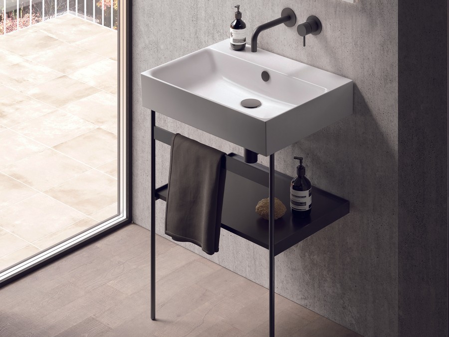 Well-positioned Catalano sanitaryware scheme - large-format stone walls, freestanding bath placed clear of joist-parallel runs, wall-hung WC with proper soil-pipe centre-line, basin with generous side clearance, integrated lighting positioned at face height - the kind of considered placement that prevents every layout mistake covered in this article