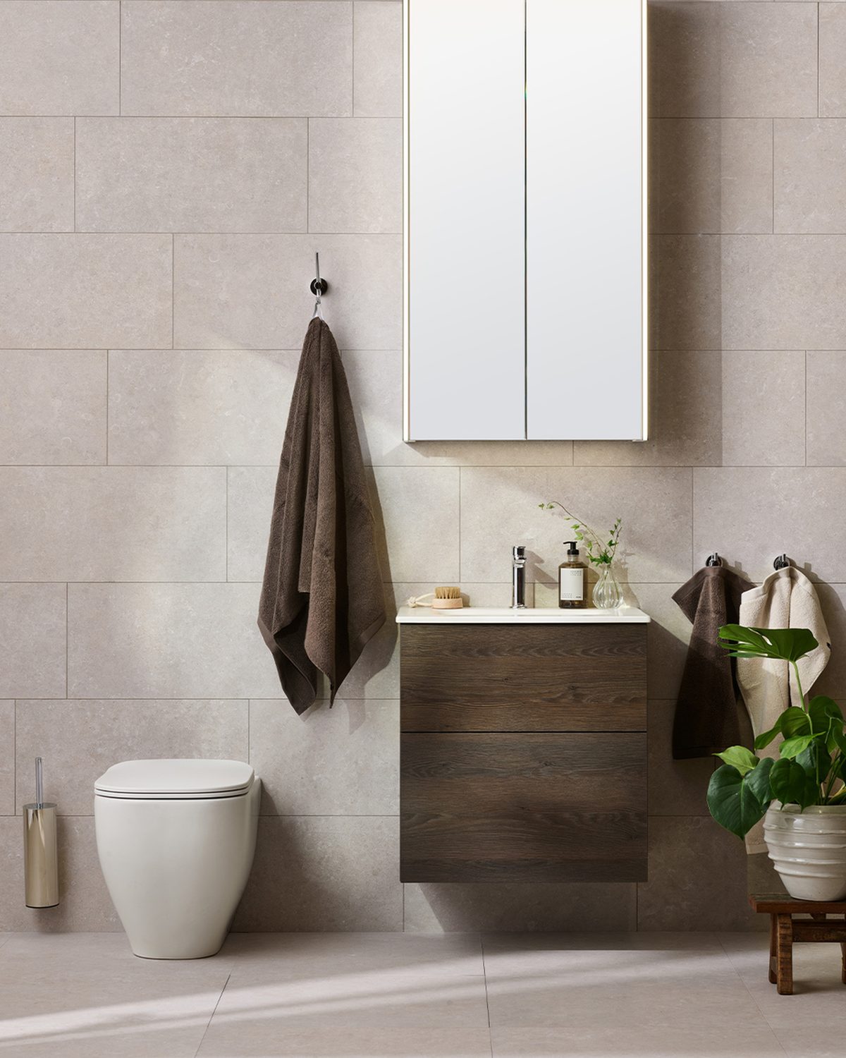 Miller from Sweden finished bathroom with stone-effect tile, wall-hung vanity and mirror cabinet