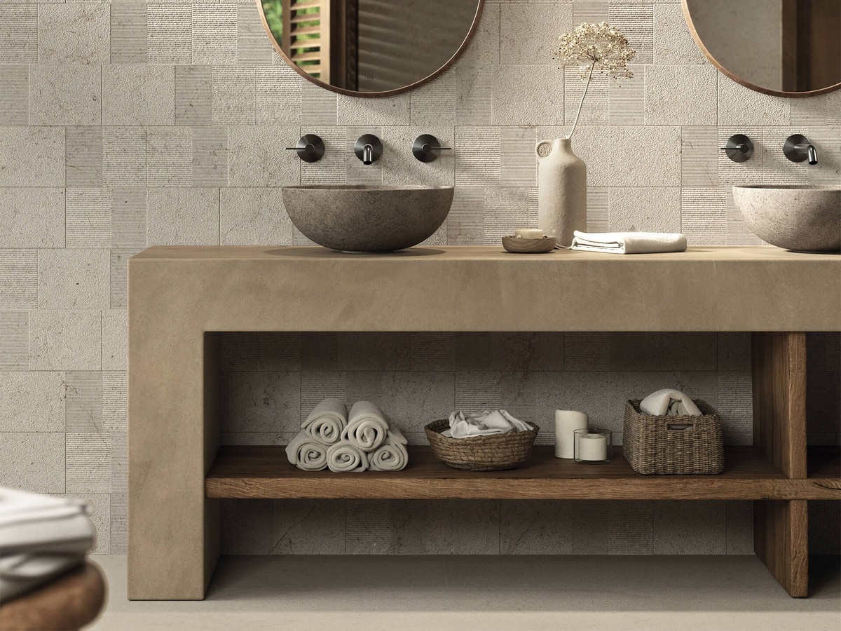 Matt, honed-look large-format stone-effect porcelain by Porcelanosa behind twin stone-look vessel basins