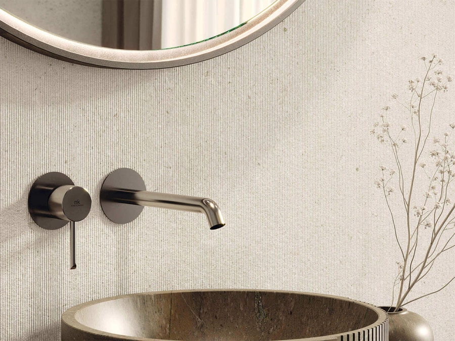 Porcelanosa large-format porcelain slab — concrete-effect 1500x750 mm porcelain in a contemporary luxury bathroom, the format that delivers calm, expensive-feeling surfaces without the maintenance regime of natural stone