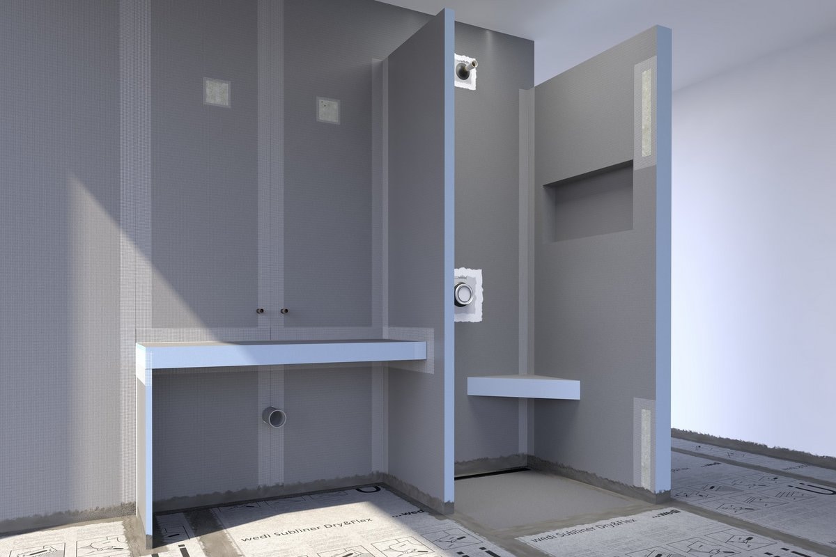 Wet room tanking system - Wedi waterproofing building boards lapped at perimeter junctions and sealed at pipe penetrations, the substrate layer that distinguishes a UK Building Regulations compliant wet room from a flush walk-in shower