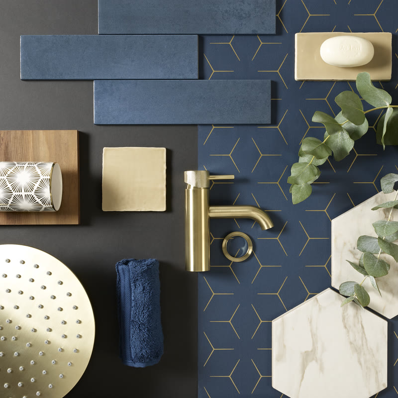 Bathroom design moodboard with brushed brass fixtures and navy tiles