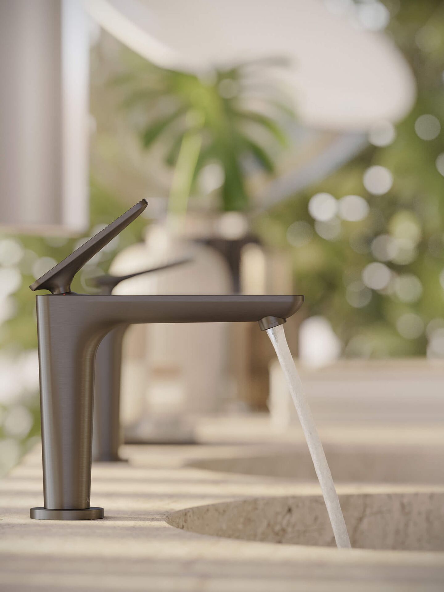 AXOR Citterio C single-lever basin mixer pouring water into a pale, textured basin.