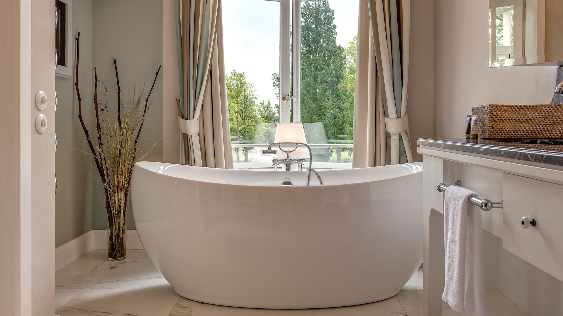 AXOR Montreux bath fittings behind a freestanding white bath at the Weissenhaus resort