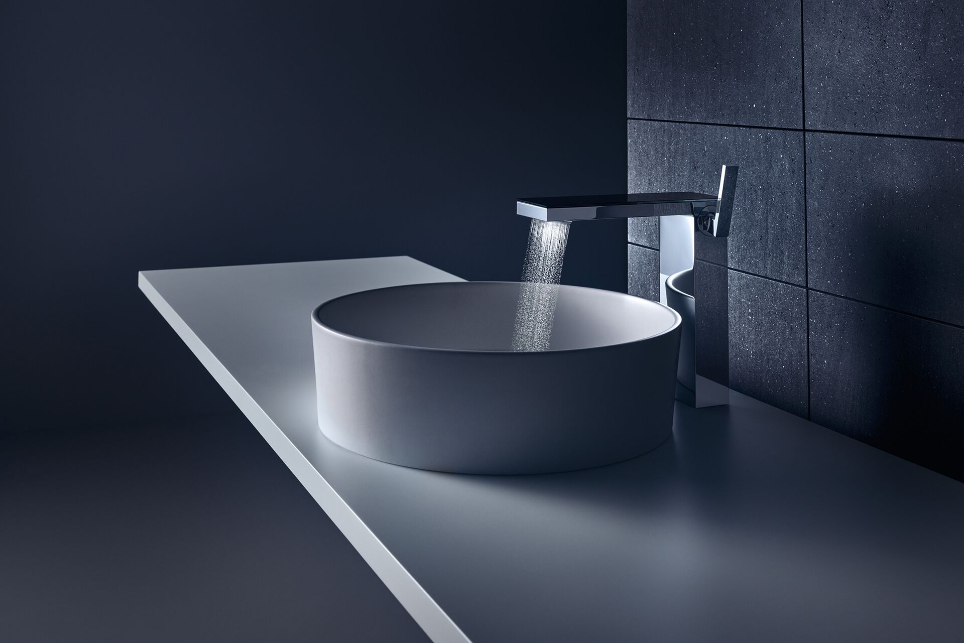 AXOR MyEdition mirror-glass basin mixer delivering fine water jets into a round basin
