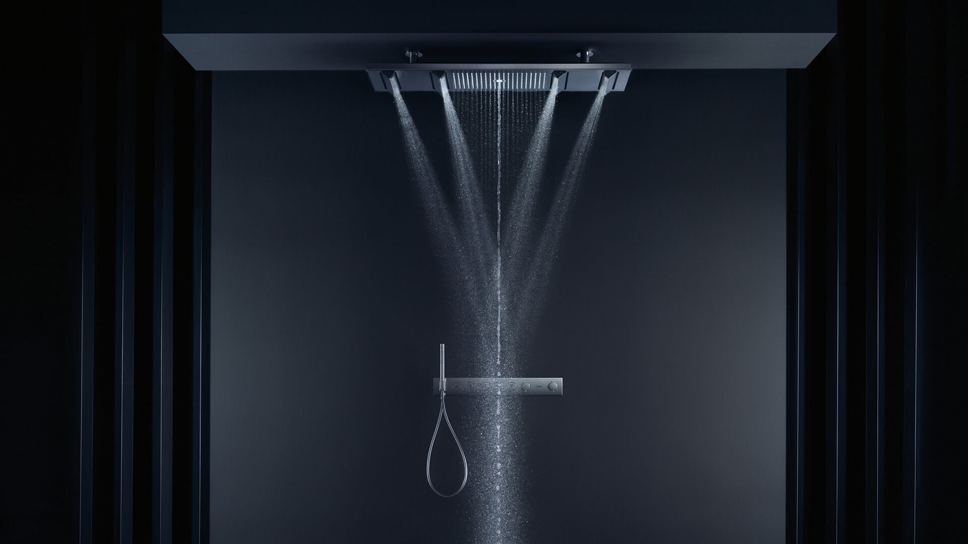 Rectangular AXOR ShowerHeaven 1200/300 sending several streams of water into a dark shower space.