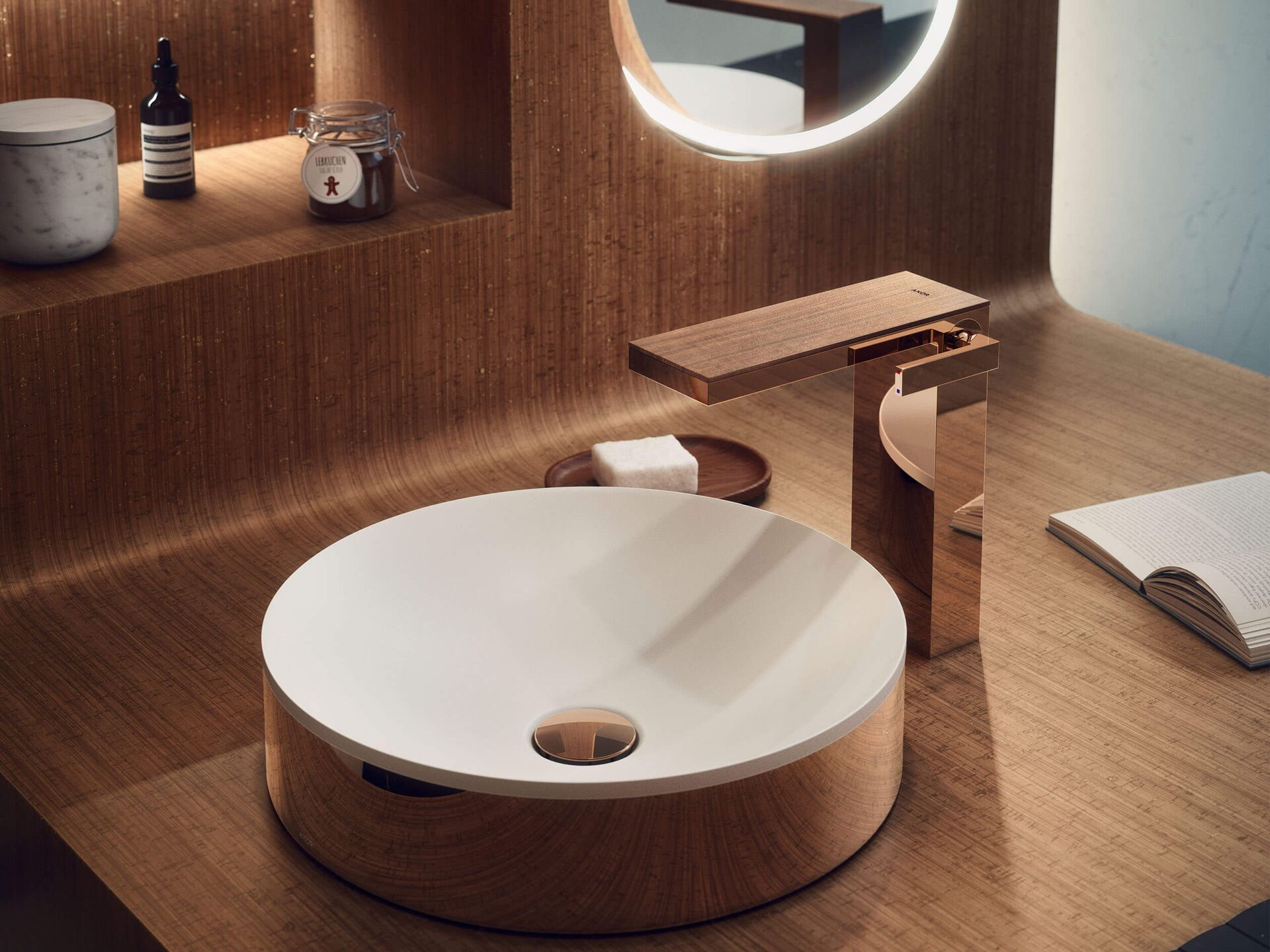Round white AXOR Suite basin with Polished Red Gold surround on a wood vanity