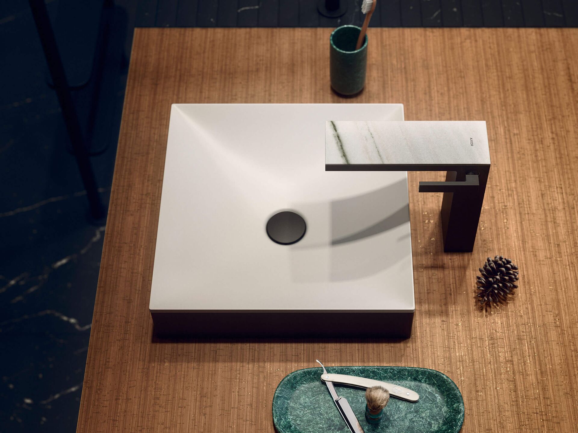 Square white AXOR Suite basin with Matt Black surround on a wood vanity
