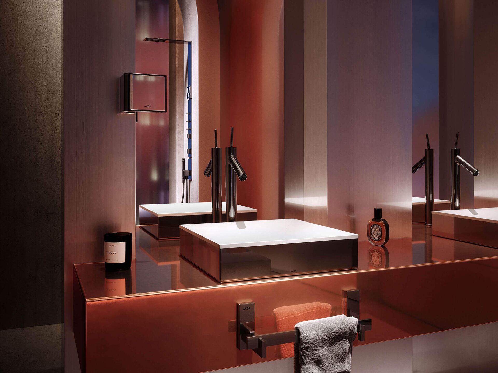 White rectangular AXOR Suite basin with a dark metal surround in a red-lit mirrored bathroom