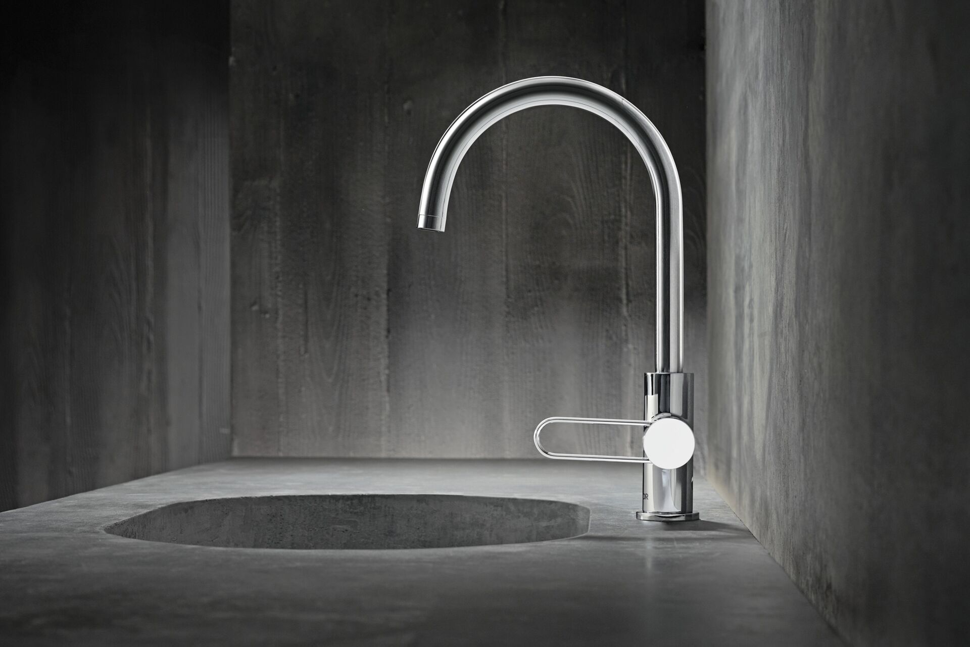 Tall curved AXOR Uno basin tap with an open loop handle