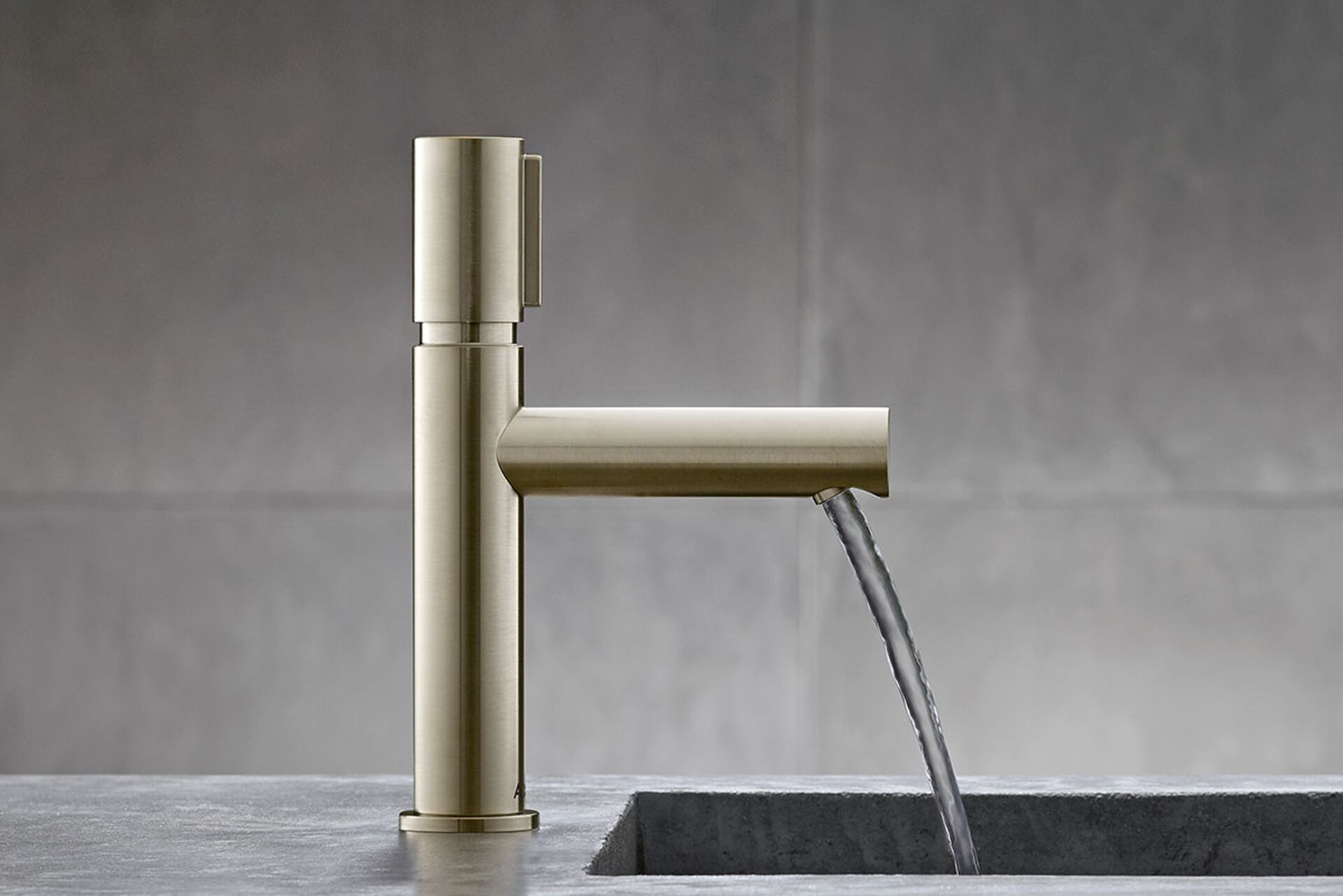 AXOR Uno basin tap with a straight spout and water flowing