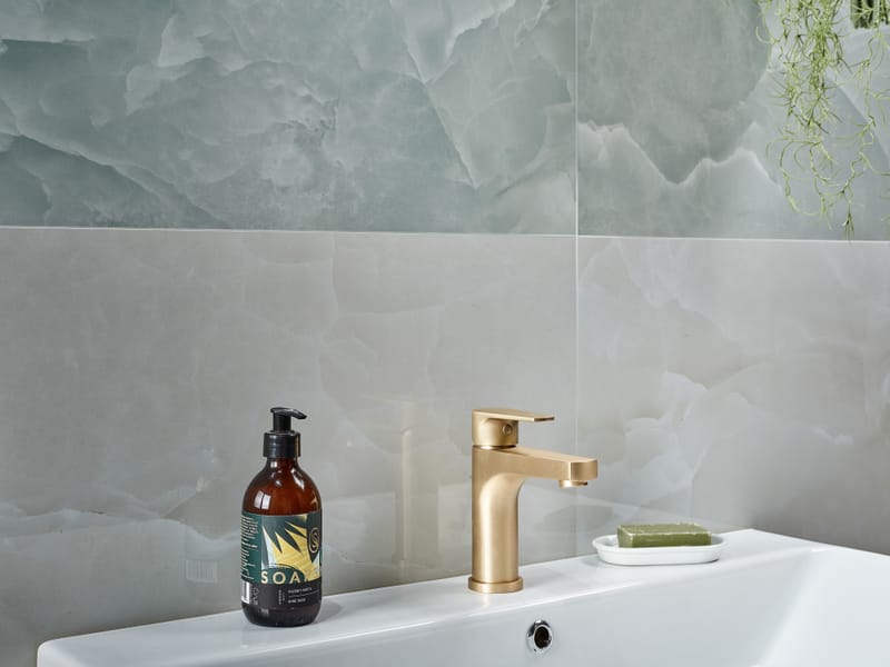 Bathroom tiles with matching grout colour creating a calm seamless wall surface