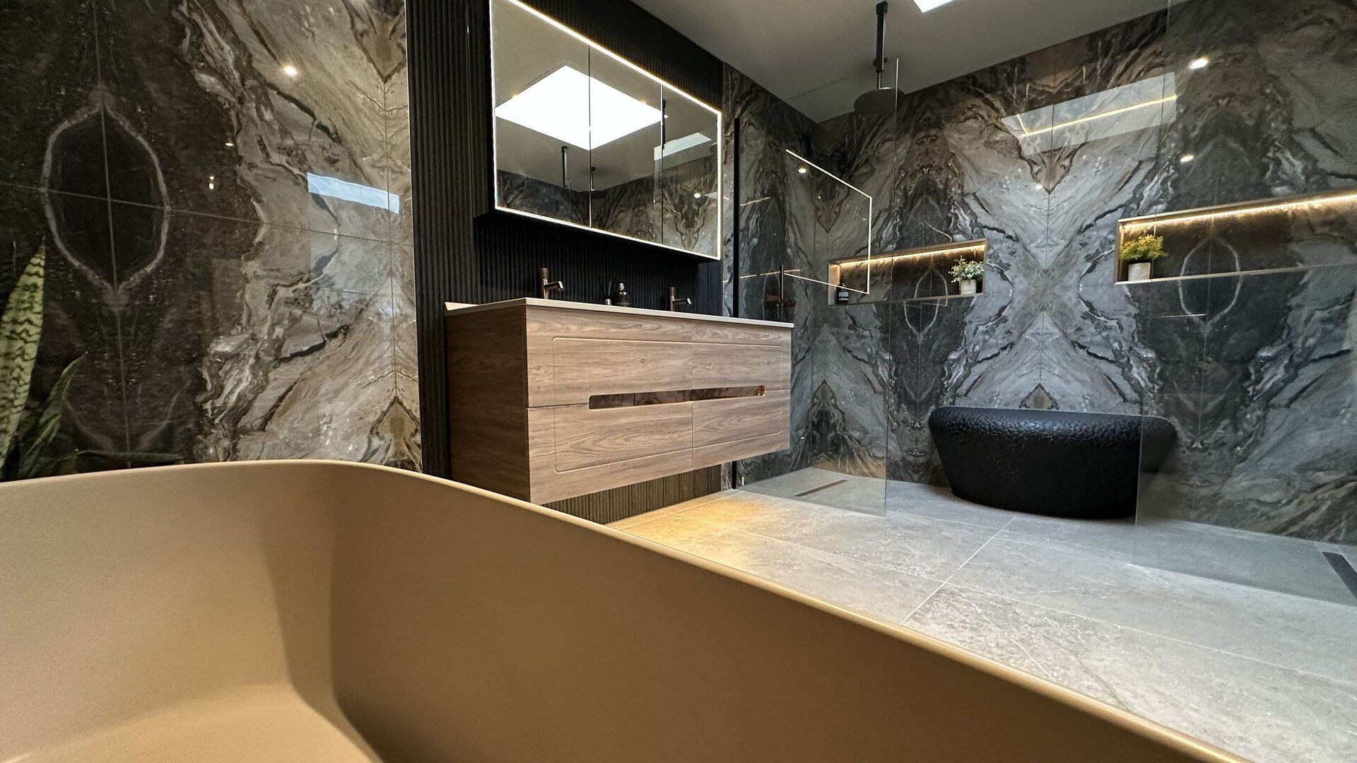 Ensuite bathroom ideas: West Mersea CO5, Ca' Pietra Magnifique Nero marble-look porcelain, BC Designs Crea bath, dual shower
