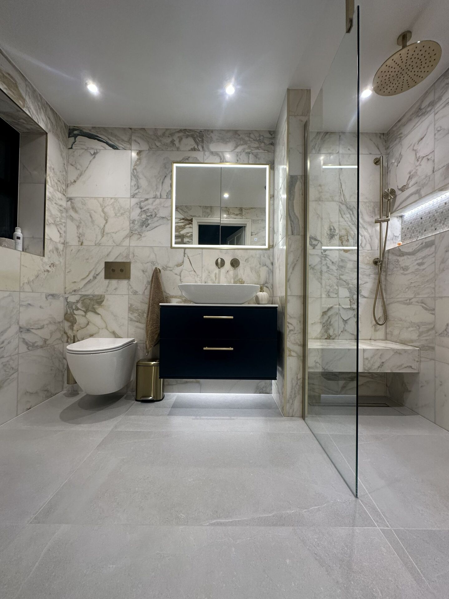 Honed Ca' Pietra marble walls meeting the porcelain wetroom floor, Chelmsford CM3 master ensuite