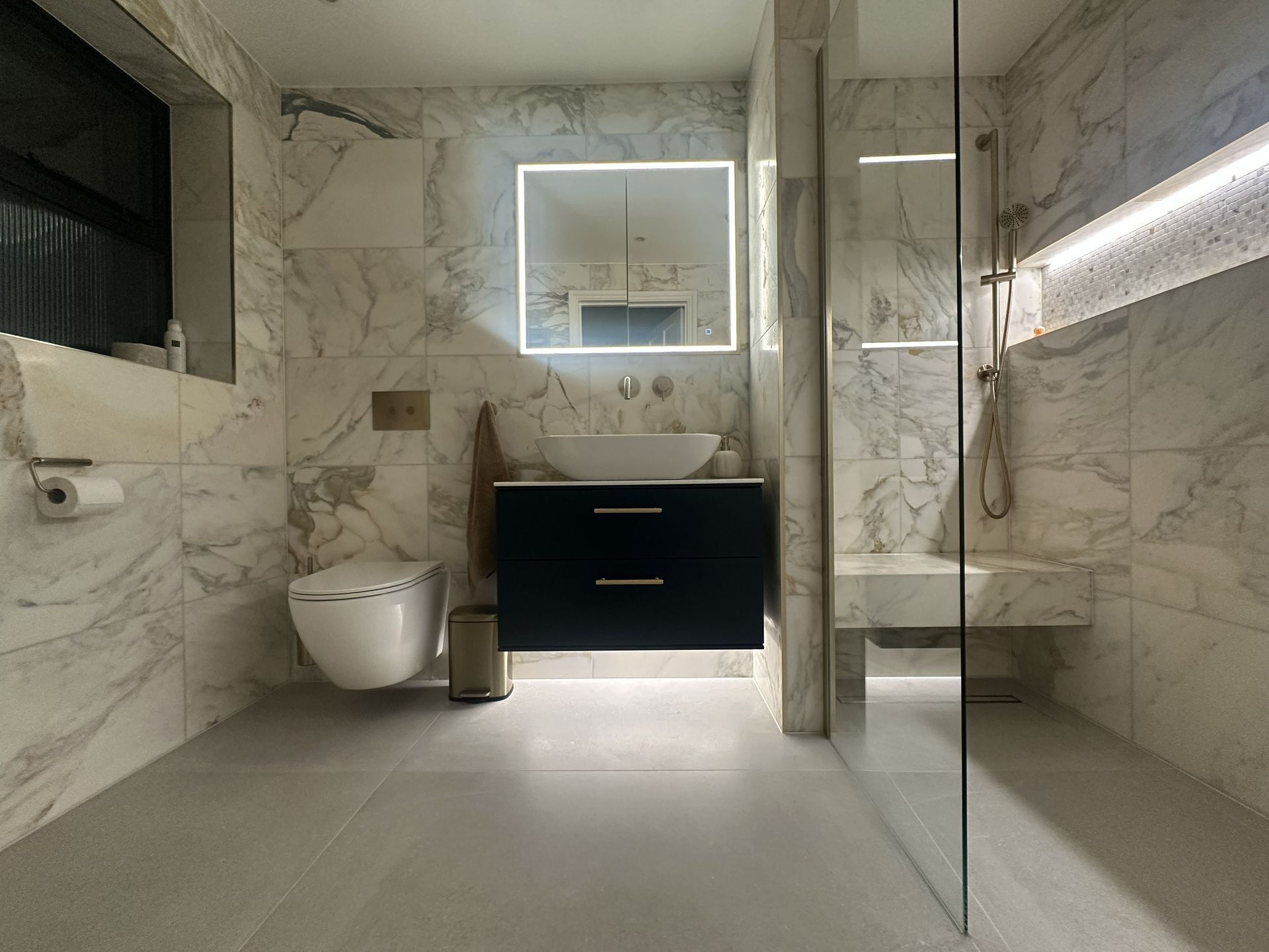 Zehnder Tetris radiator in Golden Sand beside the walk-in shower, Chelmsford CM3 master ensuite