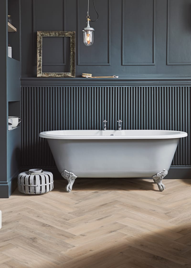 Completed luxury bathroom featuring herringbone tiles with elegant fixtures and timeless design
