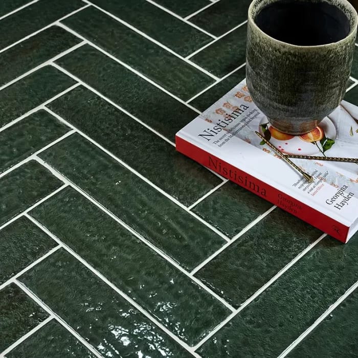 Green porcelain herringbone tiles demonstrating how grout colour affects the overall pattern appearance