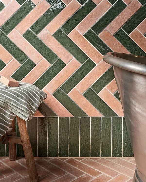 Horizontal herringbone tile layout widening a bathroom space visually