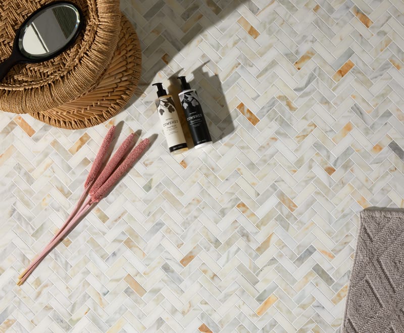 Marble herringbone mosaic tiles showing how smaller formats create intricate pattern density