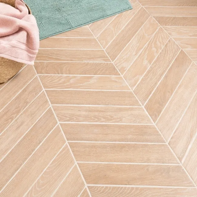 Chevron hazel wood-effect floor tiles showing sharp directional V-pattern