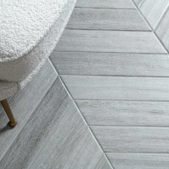 Chevron smoky wood-effect floor tiles showing directional pattern for wetrooms and bathrooms