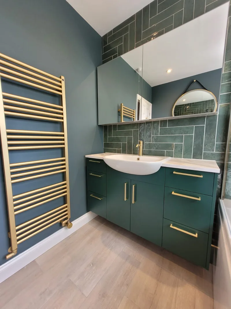 Straight herringbone green tiles in finished bathroom installation by Bowmans Essex