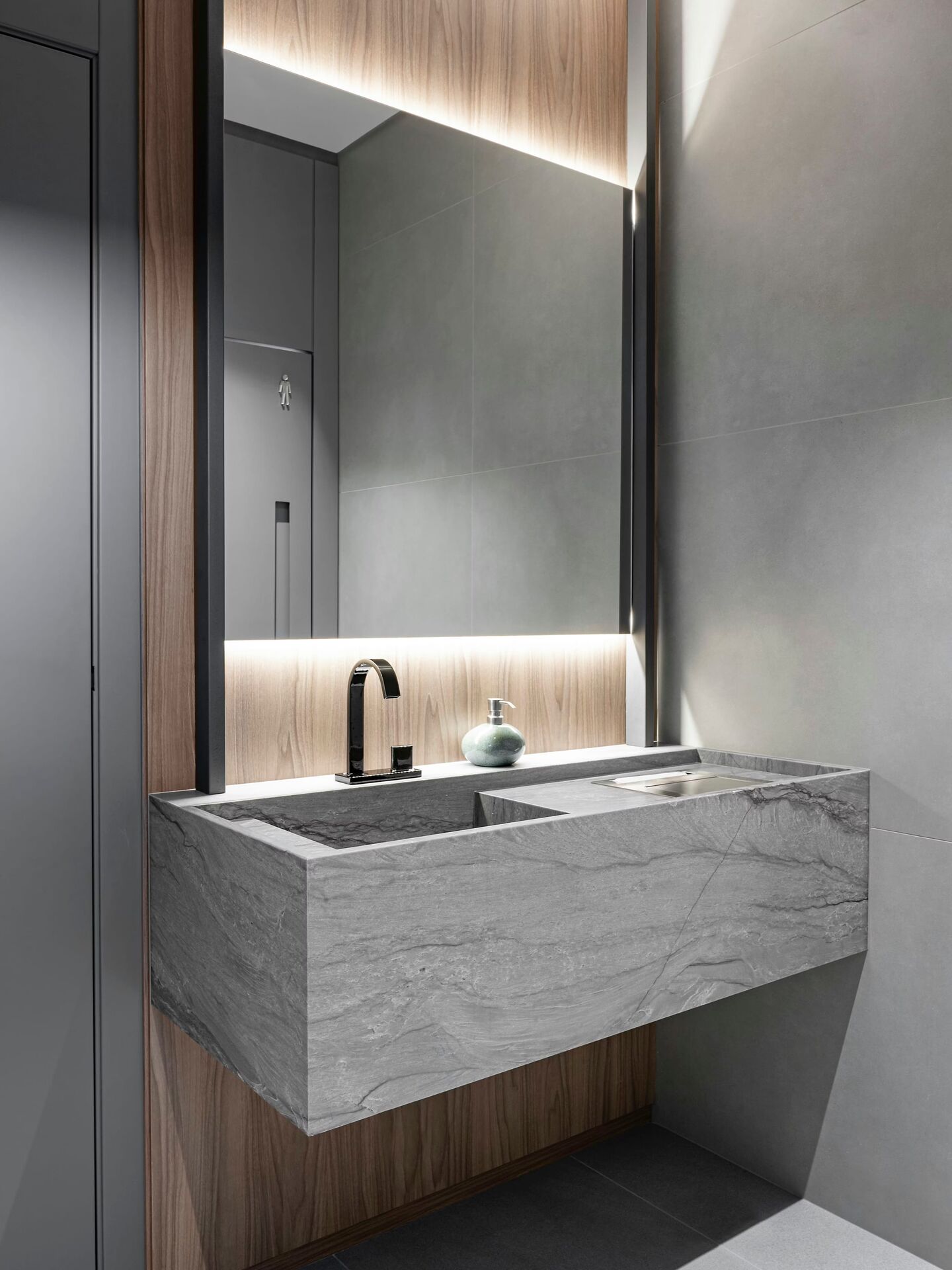 Cosentino Costa Azul engineered stone formed into a floating vanity block with an integrated basin, its grey veining carried round the corners with no metal trim