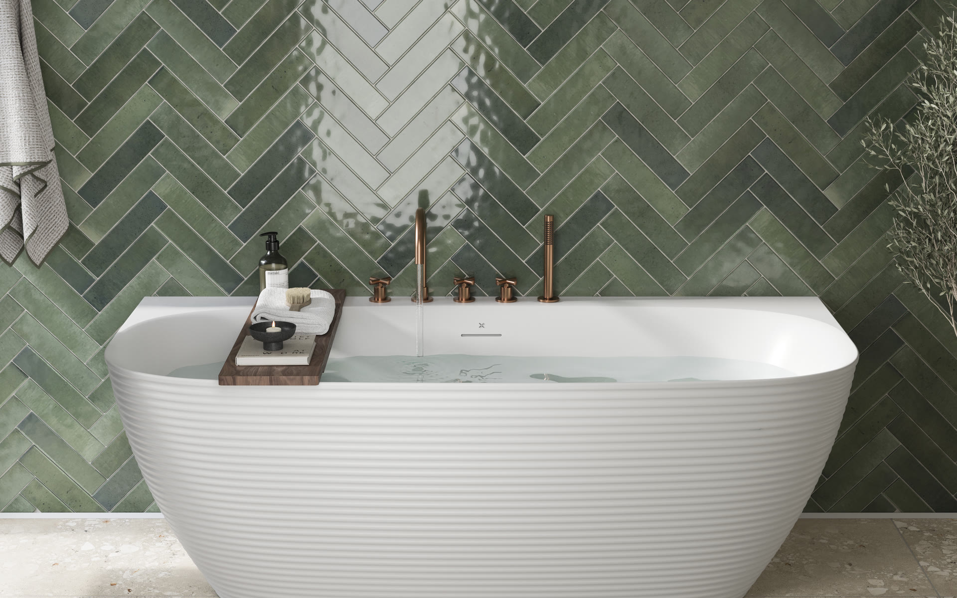 Copper bath filler and green herringbone tile detail — the finishing layer, whichever way the decision goes