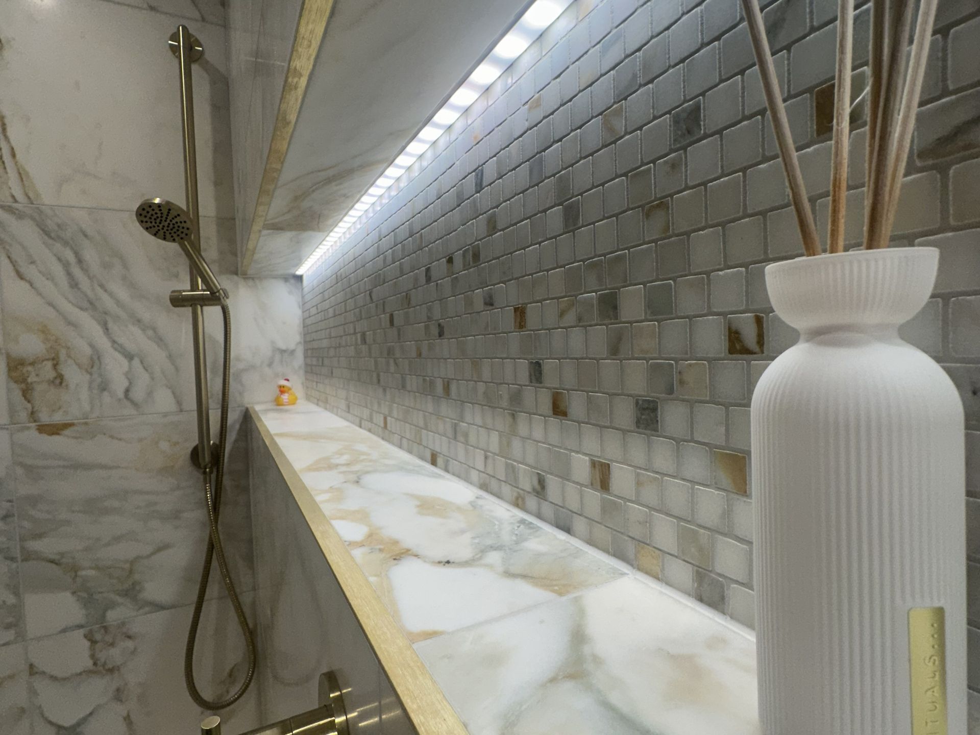 Long lit shower niche with marble mosaic backing, a marble sill and brushed trim, Chelmsford CM3 master ensuite