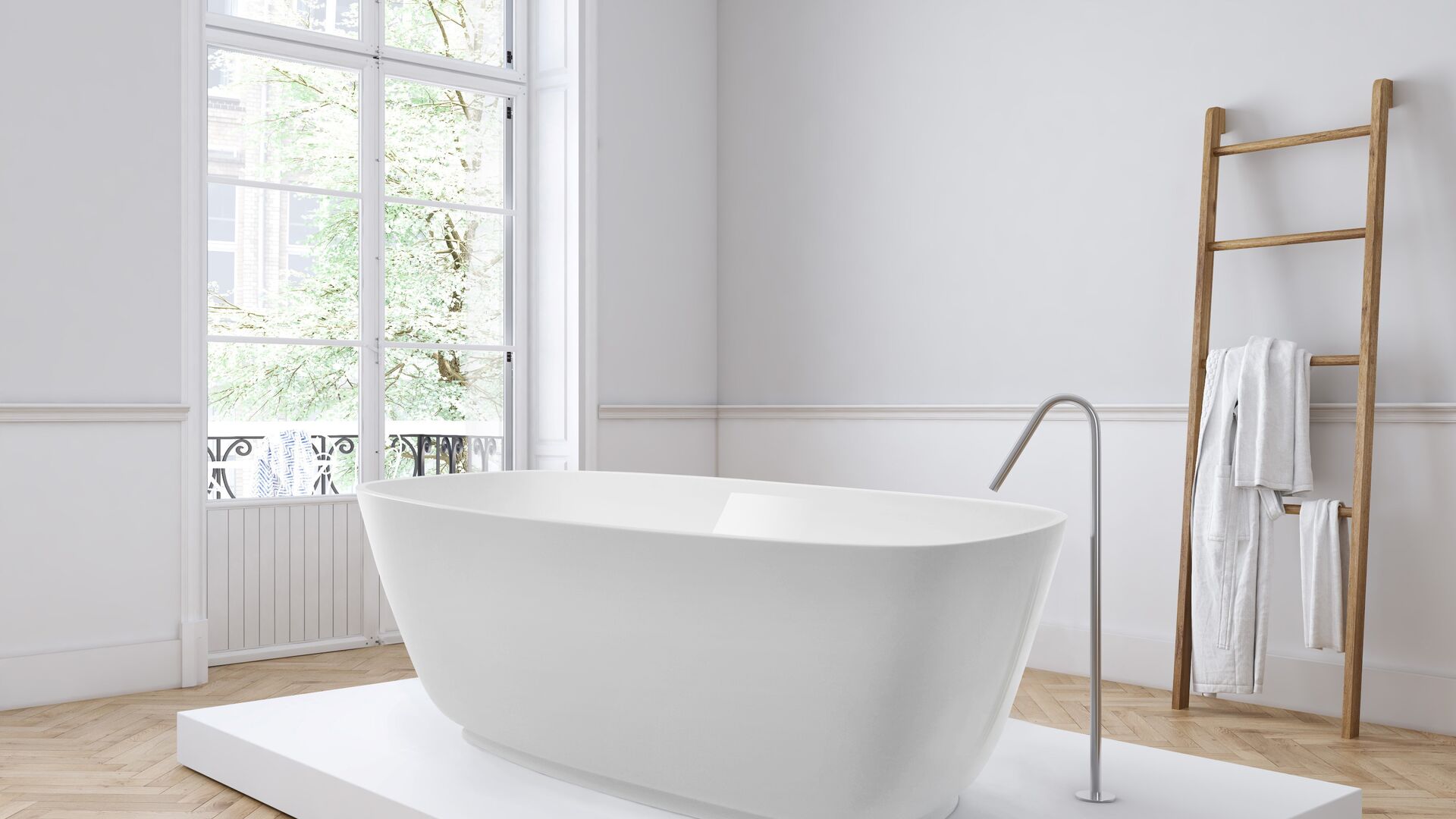 Freestanding bath in a warm-lit bathroom interior