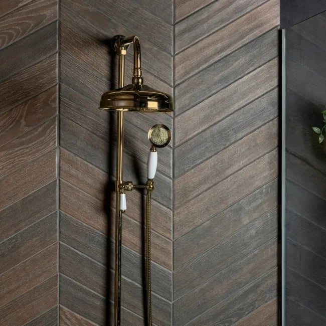 Chevron tile layout on shower wall with wood-effect umber tiles forming V-shaped pattern