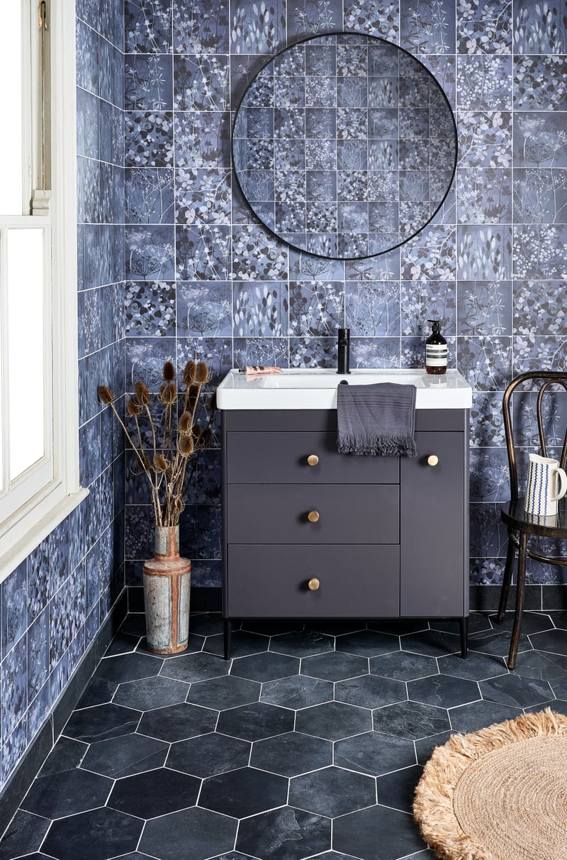 Hexagon tile floor layout with slate-effect riven hexagonal tiles in bathroom with botanical wall tiles