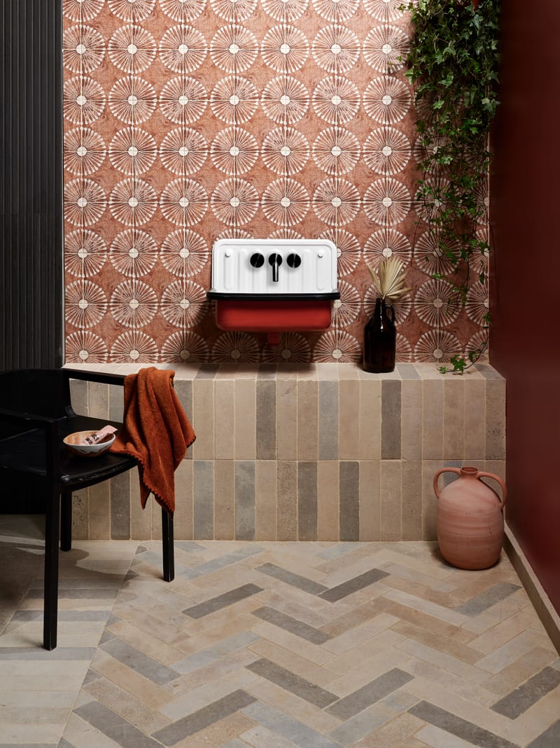 Luxury finished bathroom with tumbled limestone parquet-style tile layout demonstrating considered design