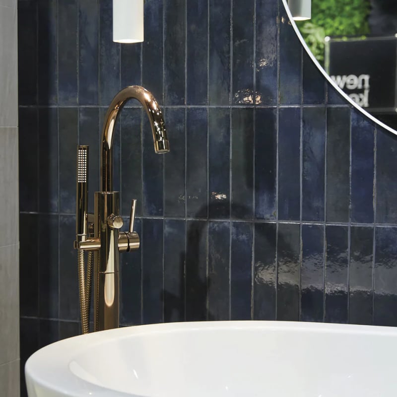 Vertical stack tile layout in modern bathroom with blue cobalt rectangular tiles stacked upright