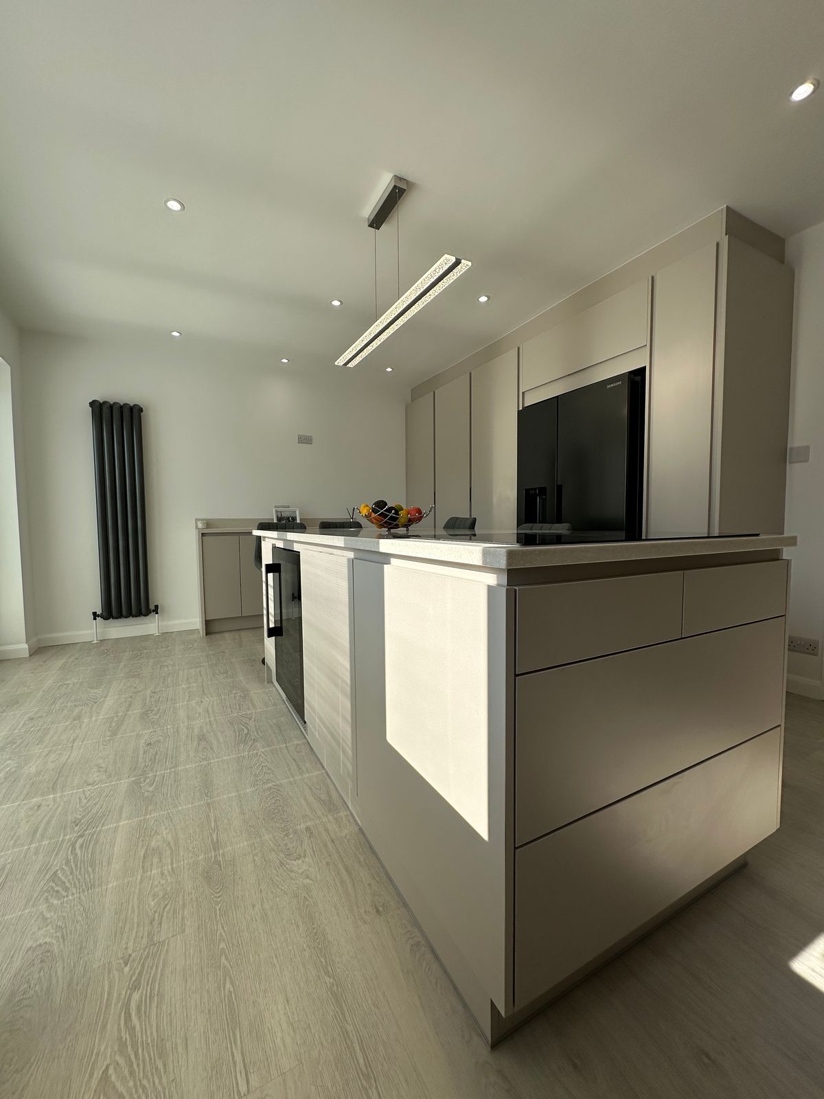 Contemporary handleless kitchen design with clean lines and integrated handles at Bowmans Essex showroom