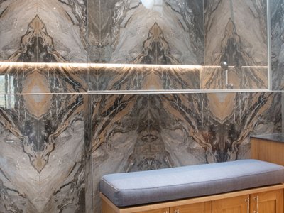 Custom bathroom craftsmanship with rainfall shower and marble tiles Halstead Essex - Bowman Bathrooms