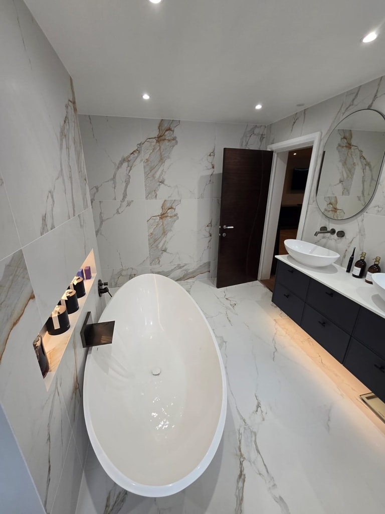 Freestanding bath and marble-tiled double vanity in a completed Billericay CM11 master ensuite