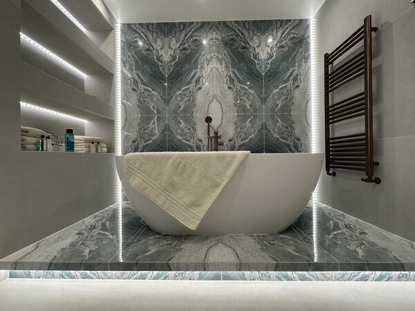 Luxury family bathroom in Bradwell with feature tile wall and freestanding bath