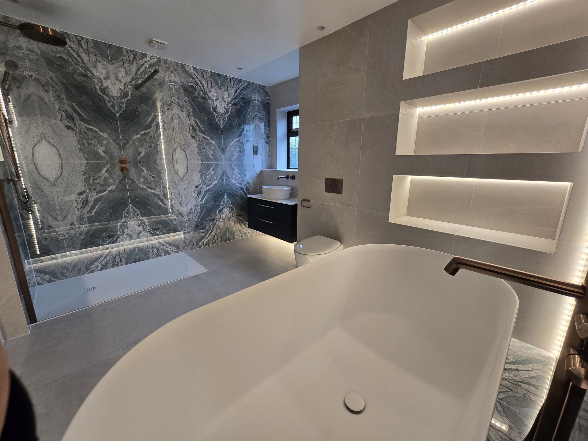 Three LED-lit recessed niches in built-out wall — Bradwell CM77 family bathroom