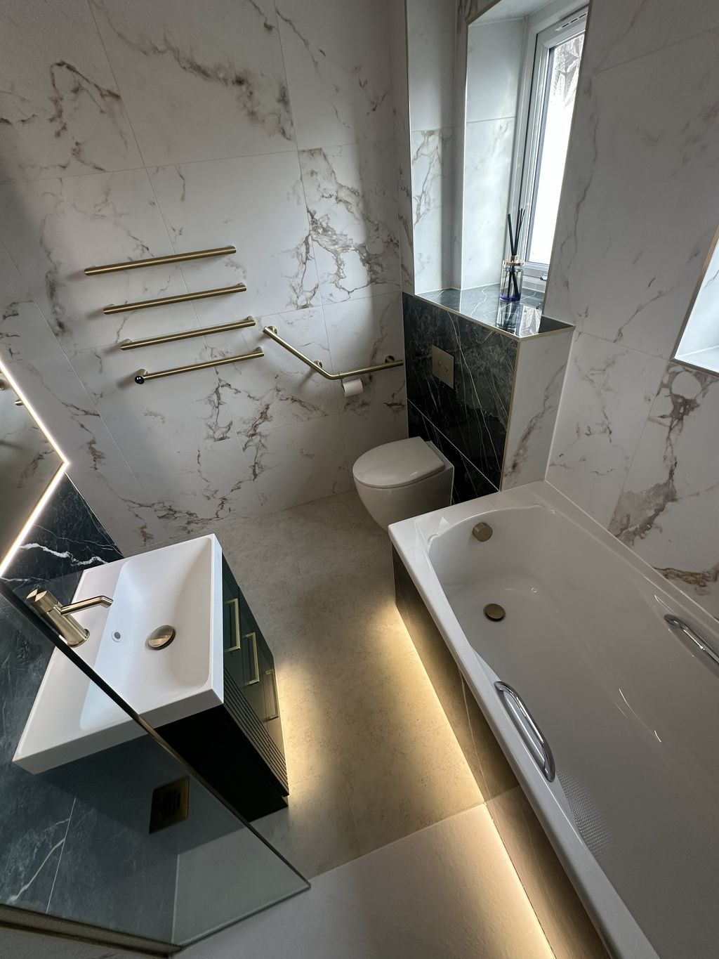 High-angle overview of compact family bathroom with green tiles and brushed brass — Braintree CM7