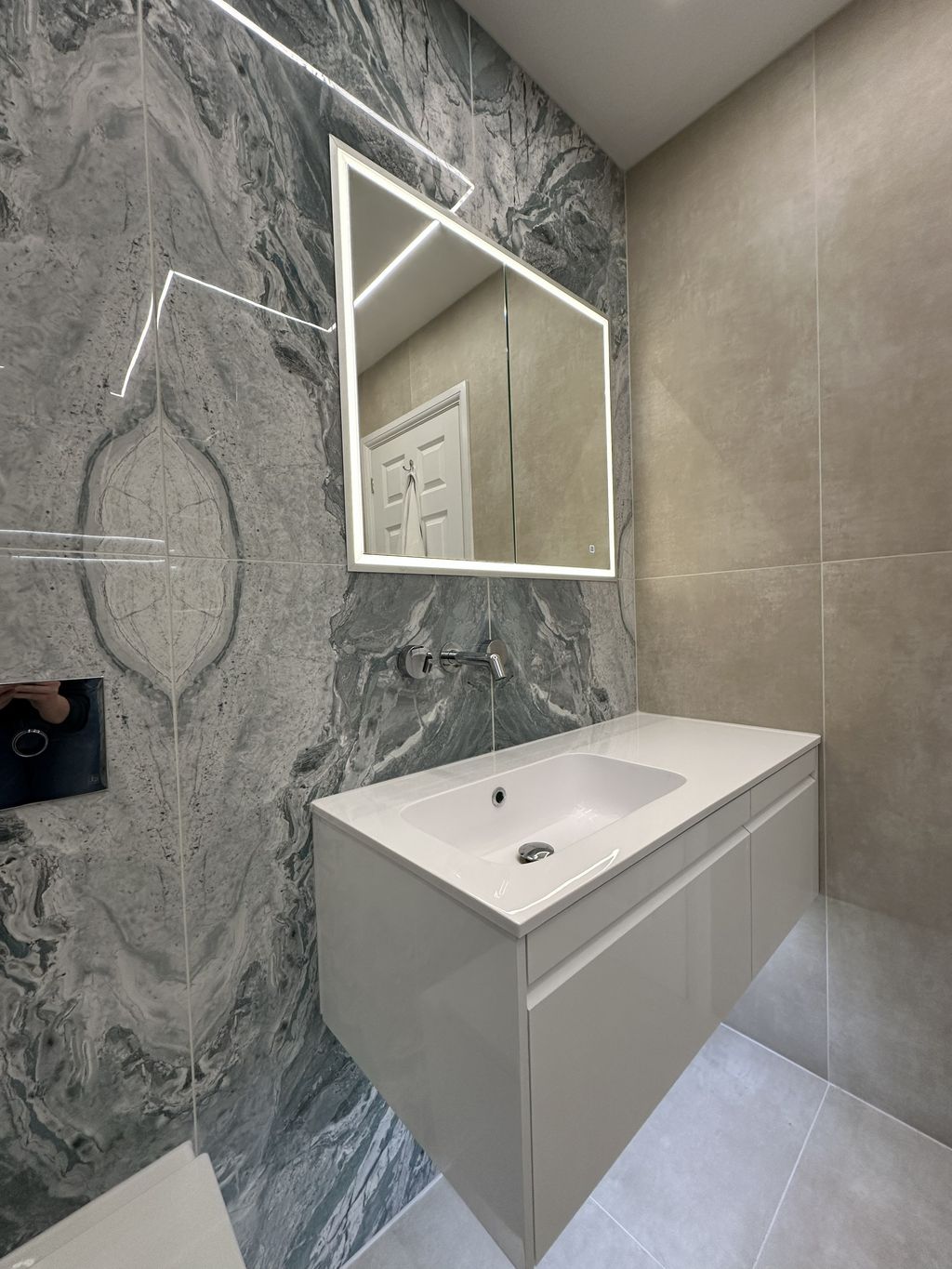 Calypso Loreto vanity with HiB Vanquish LED mirror and wall-mounted JTP tap against Ocean Magnifique feature wall in Braintree CM7