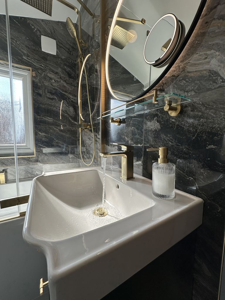 Roper Rhodes basin with brushed brass mixer tap and Ca' Pietra marble behind glass screen in Braintree CM7 family bathroom
