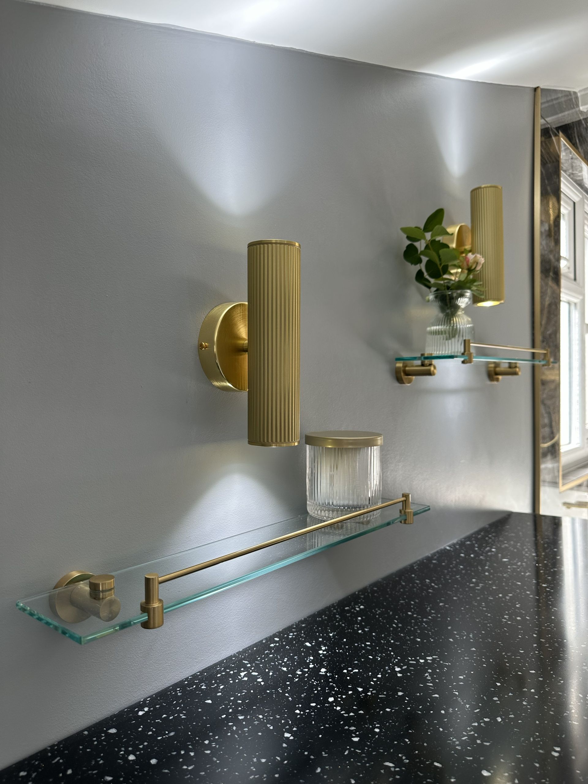 Roper Rhodes brushed brass wall lights and glass shelves with matching brass accessories in Braintree CM7 family bathroom