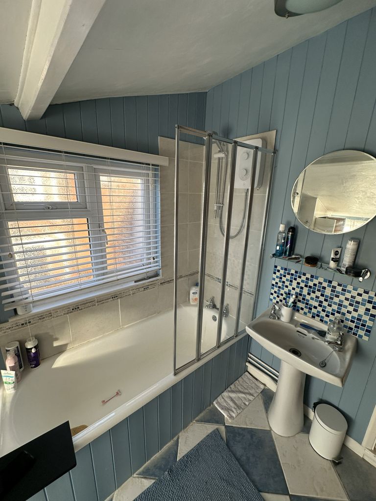Original family bathroom Braintree CM7 before renovation showing shower over bath with glass screen and mosaic splashback