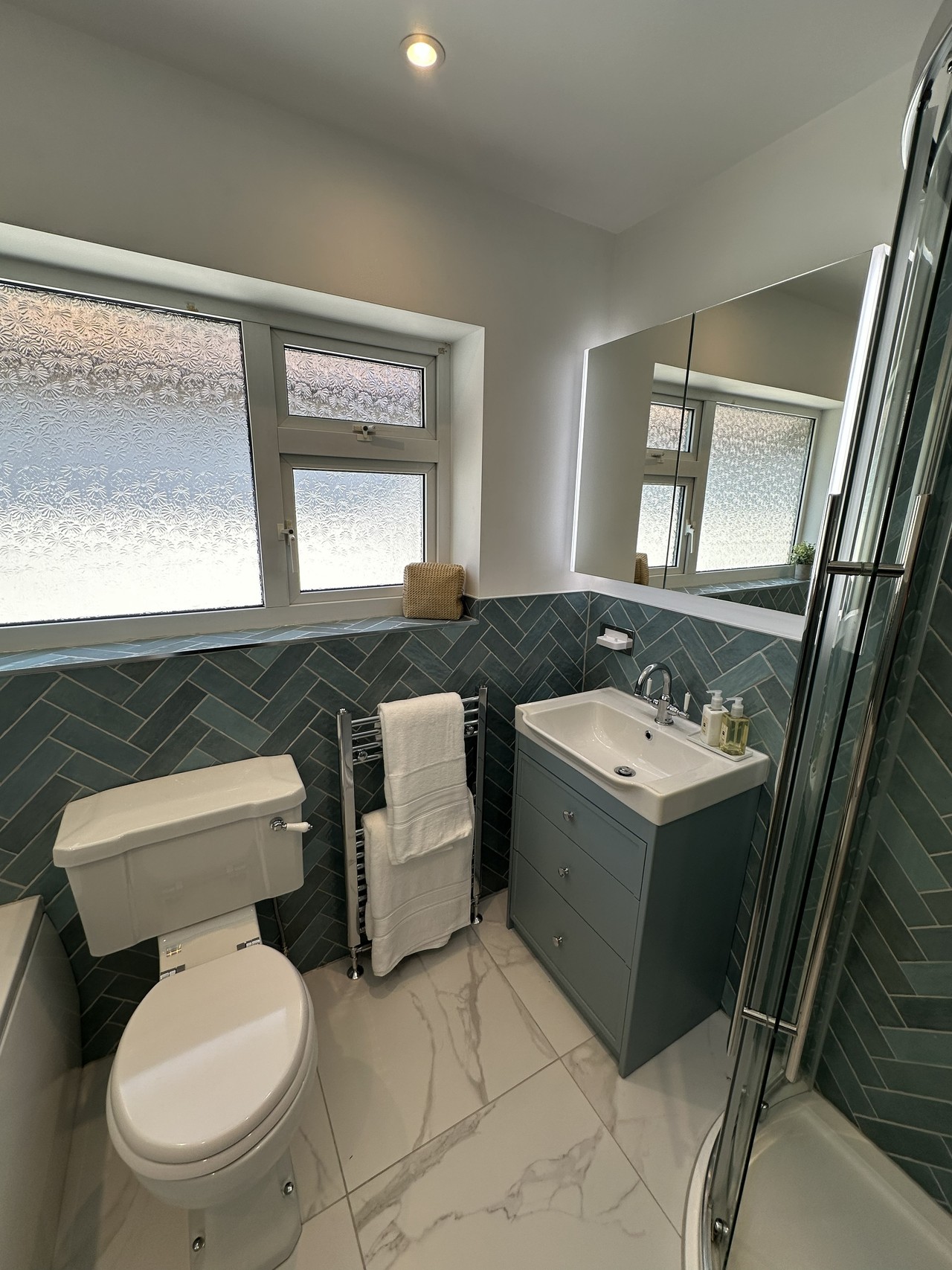 Window wall showing Burlington WC, chrome towel rail, and Roper Rhodes Apex vanity beneath frosted windows in Brentwood CM13 bathroom