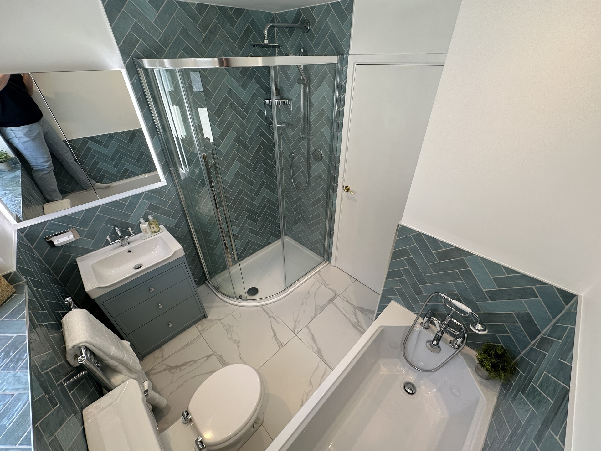 Bird's-eye view of Brentwood CM13 double fixture family bathroom showing bath, quadrant shower, vanity, and Ca' Pietra Kensington marble floor