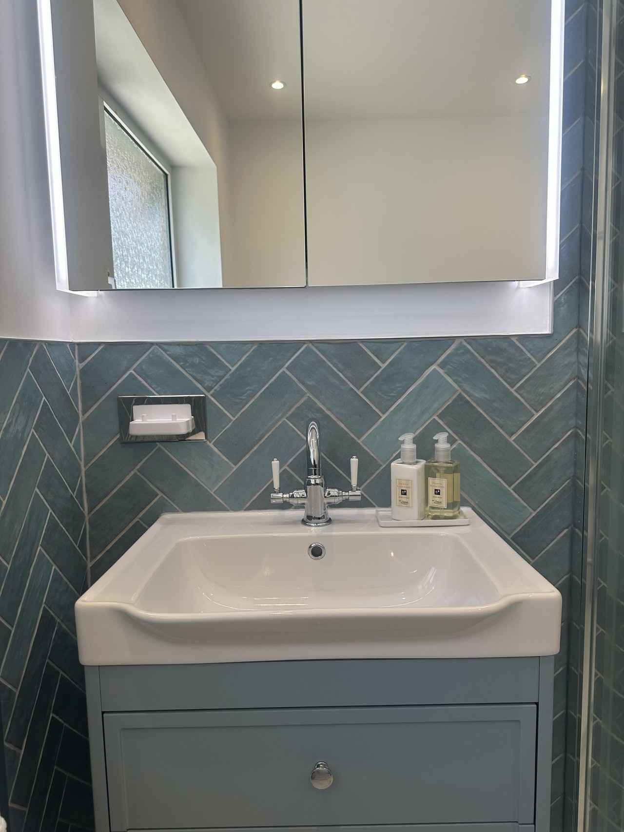 Roper Rhodes Academy basin with Keswick chrome mixer and LED mirrored cabinet against Oasis Aqua herringbone tiles in Brentwood CM13