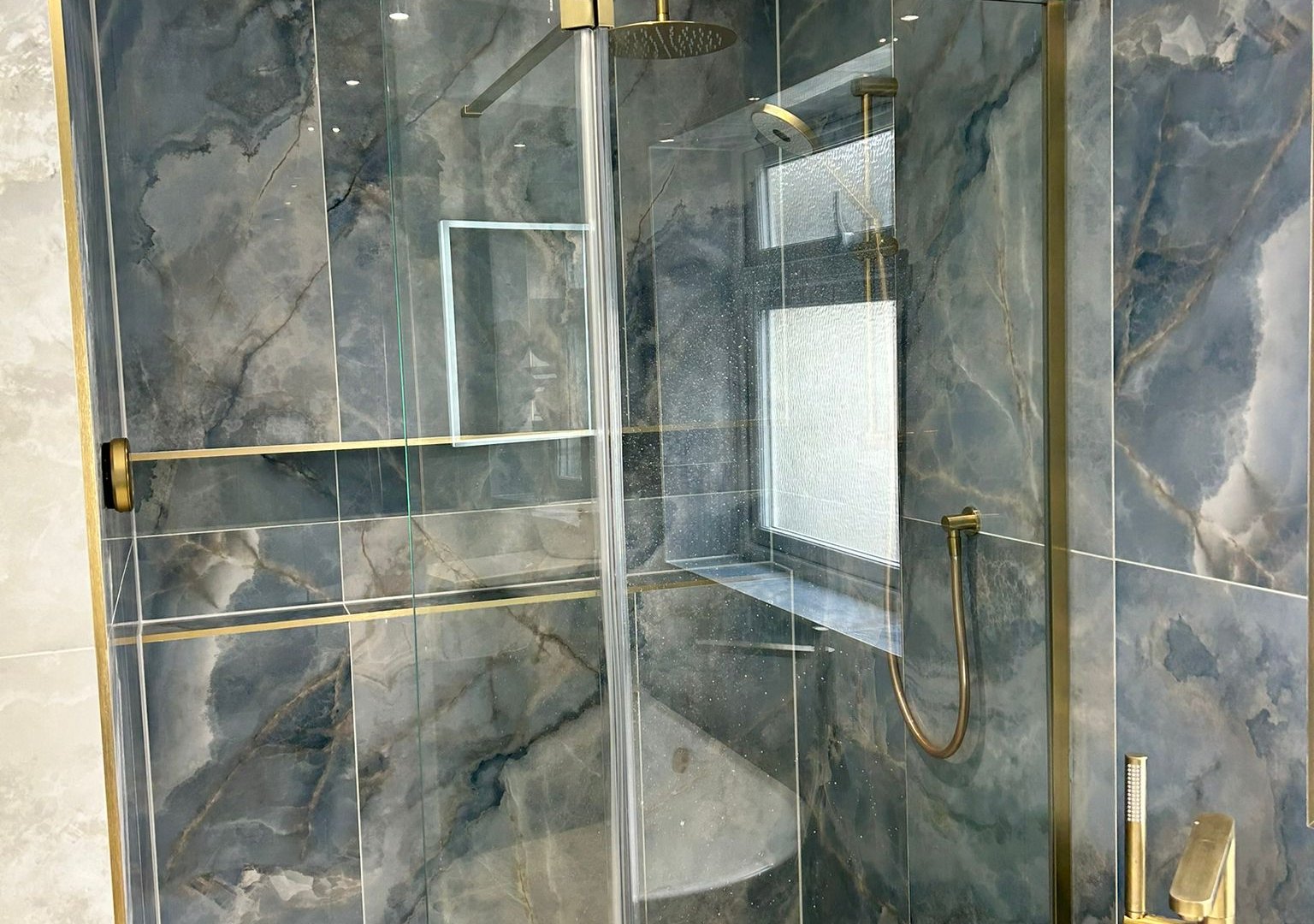 Modern bathroom with frameless glass wetroom and recessed niche